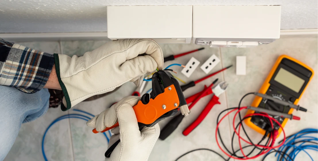 Electrician working with tools and wires